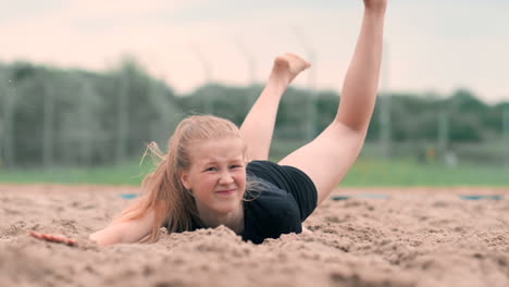 Female-volleyball-player-in-the-fall-hits-the-ball-in-slow-motion-on-the-beach